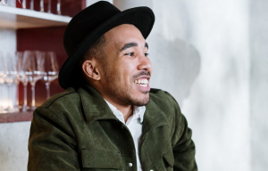 man in green coat smiling